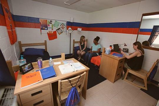 学生们坐在基斯顿大学宿舍的床上.